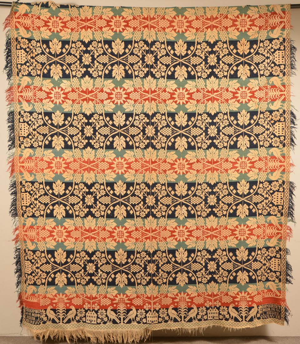 Antique Four Color Ohio Wool Coverlet.: Antique Four-Color Ohio Wool Coverlet. Red, navy and light blue, with fringe on three sides. The border composed of birds flanking a tall sunflower alternating with houses. The main filed having grape