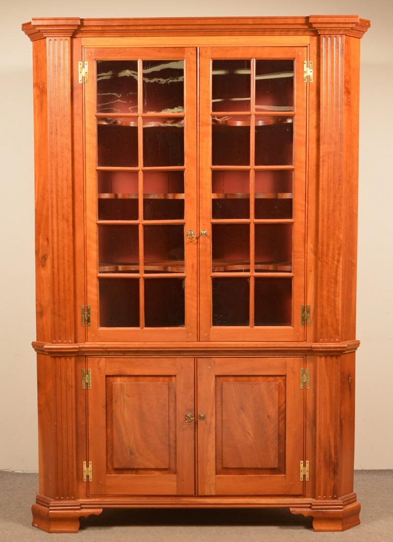Chippendale Style Cherry Architectural Corner Cupboard.: Vintage Chippendale-Style Cherry Architectural Corner Cupboard. Single part with bold stepped molded cornice above two glazed doors and reeded stiles, above two lower raised panel doors reeded stiles,
