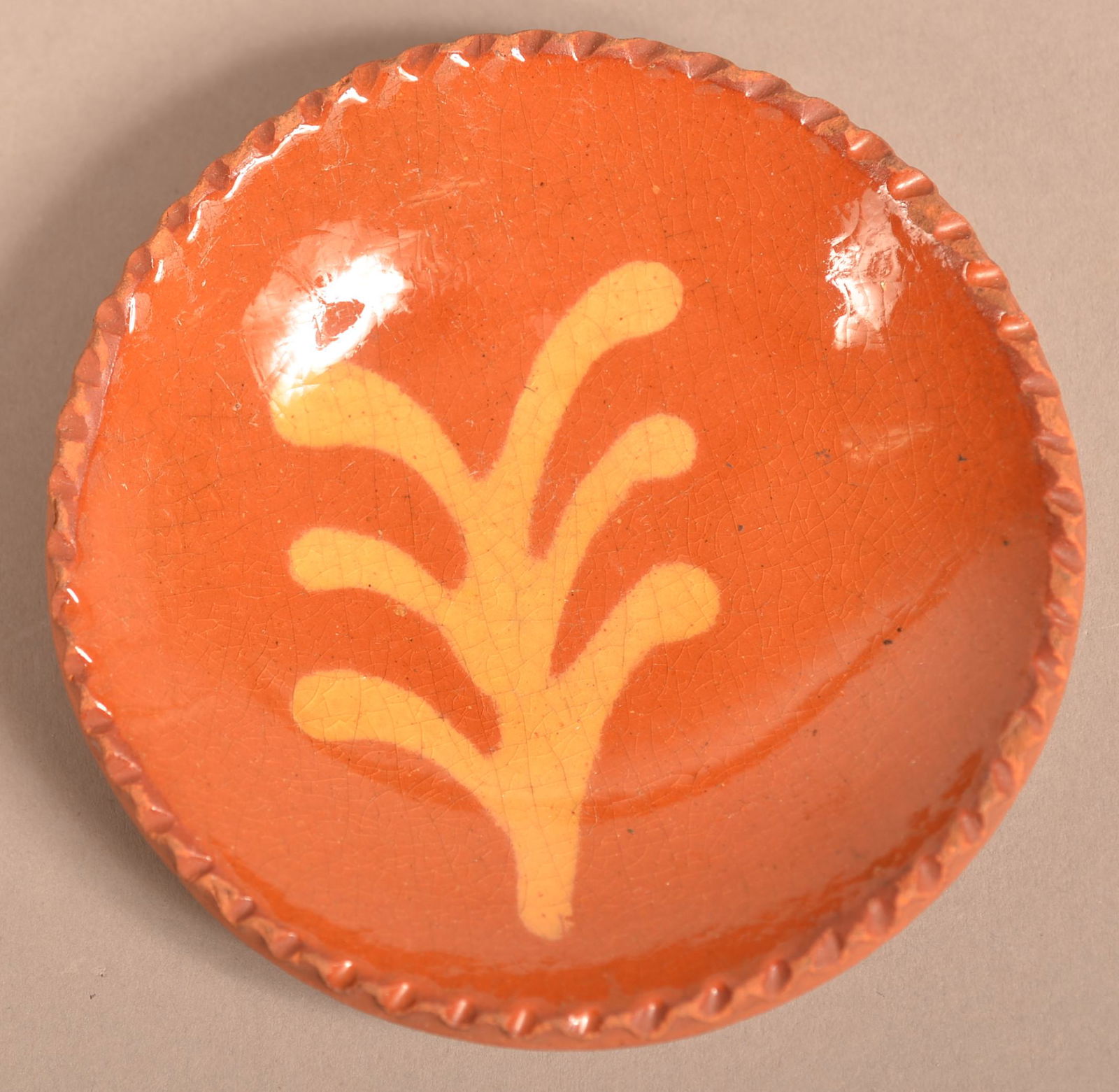 PA Yellow Slip Decorated Redware Cup Plate.: Pennsylvania 19th Century Yellow Slip Decorated Redware Cup Plate. Coggle wheel edge. 4" diam. Condition: Very good with minor edge wear.