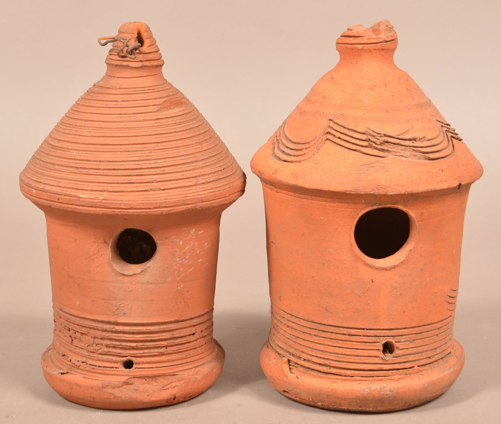 Two Schofield Unglazed Redware Birdhouses.: Two Unglazed Redware Birdhouses. Attributed to Henry Schofield, Cecil County, MD. Early 20th century. Turned concentric rings. 10-1/2"h. Condition: Fair with chips and wear. One with loss of hanging f