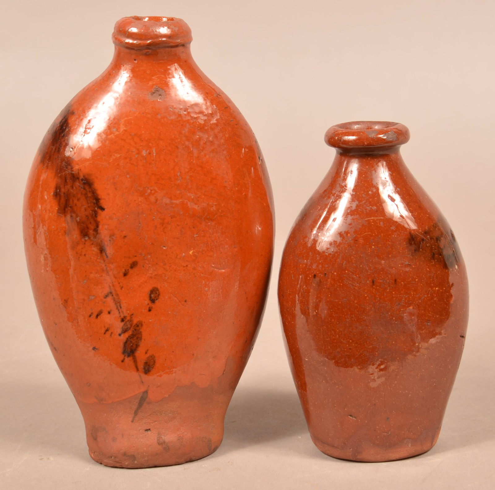 Two Pennsylvania 19th Century Glazed Redware Flasks.: Two Pennsylvania 19th Century Glazed Redware Flasks. 6" and 8-1/4" diam. Condition: Good with minor wear.