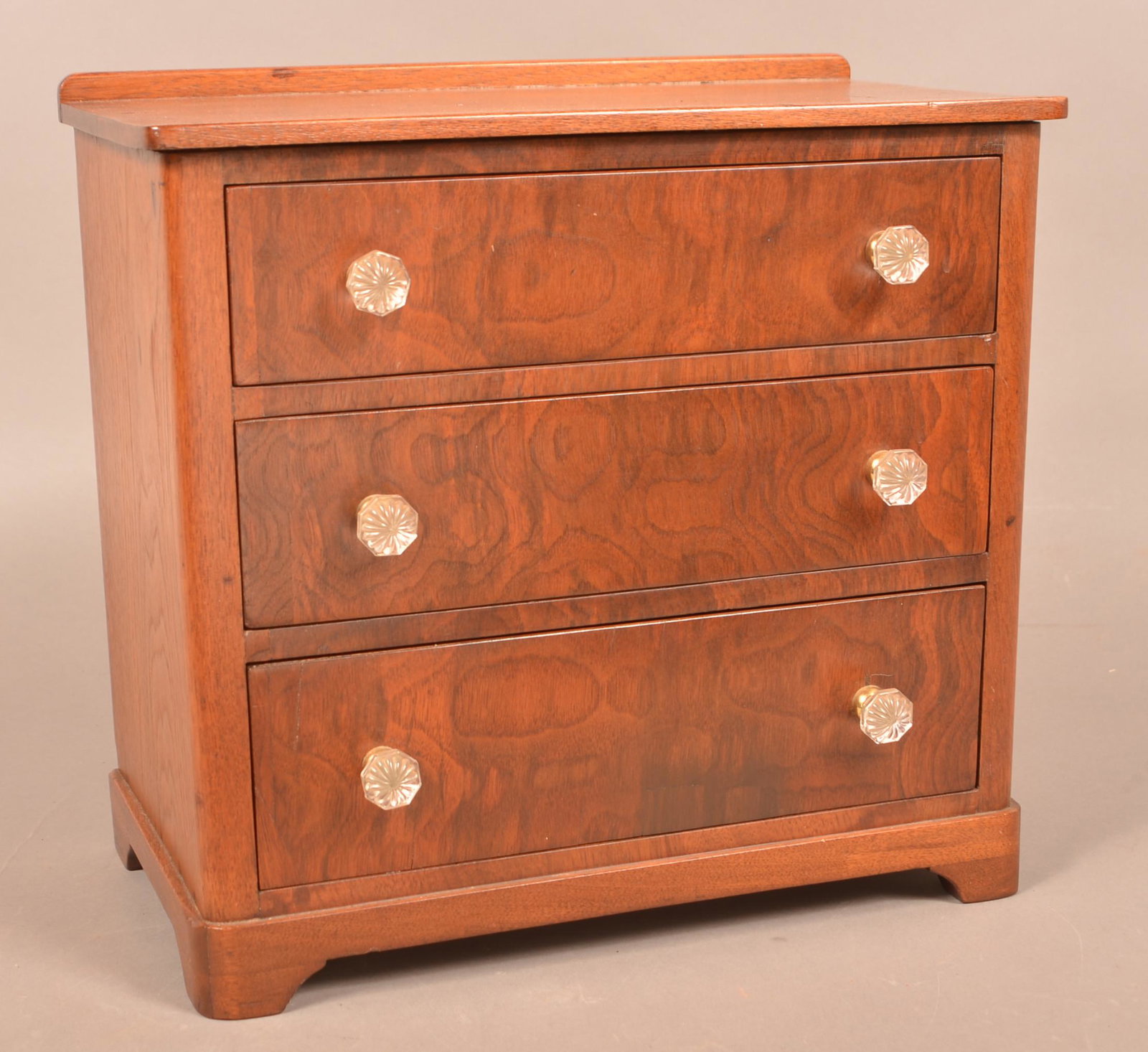 Federal Walnut Miniature Chest of Drawers.: Federal Walnut Miniature Chest of Drawers. Burl mahogany veneered drawer fronts. Three full width dovetailed graduated drawers and bracket base. Colorless glass rosette pulls. 14-1/2"h. x 15-1/4"w. x 