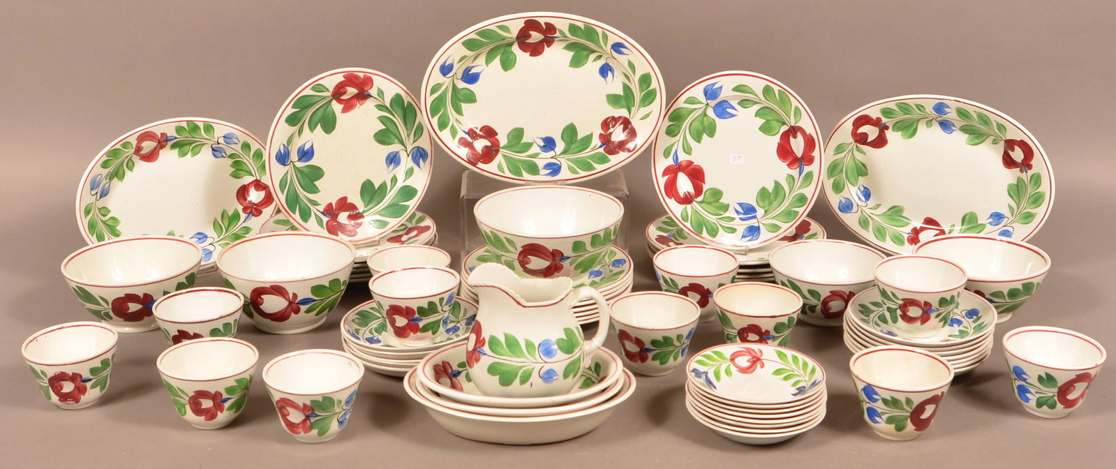 62 Pieces of Late Adams Rose ironstone China.: 62 Pieces of Late Adams Rose Ironstone China. Including a pitcher, platters, plates, bowls, cups and saucers. Condition: Very good with minor damage.