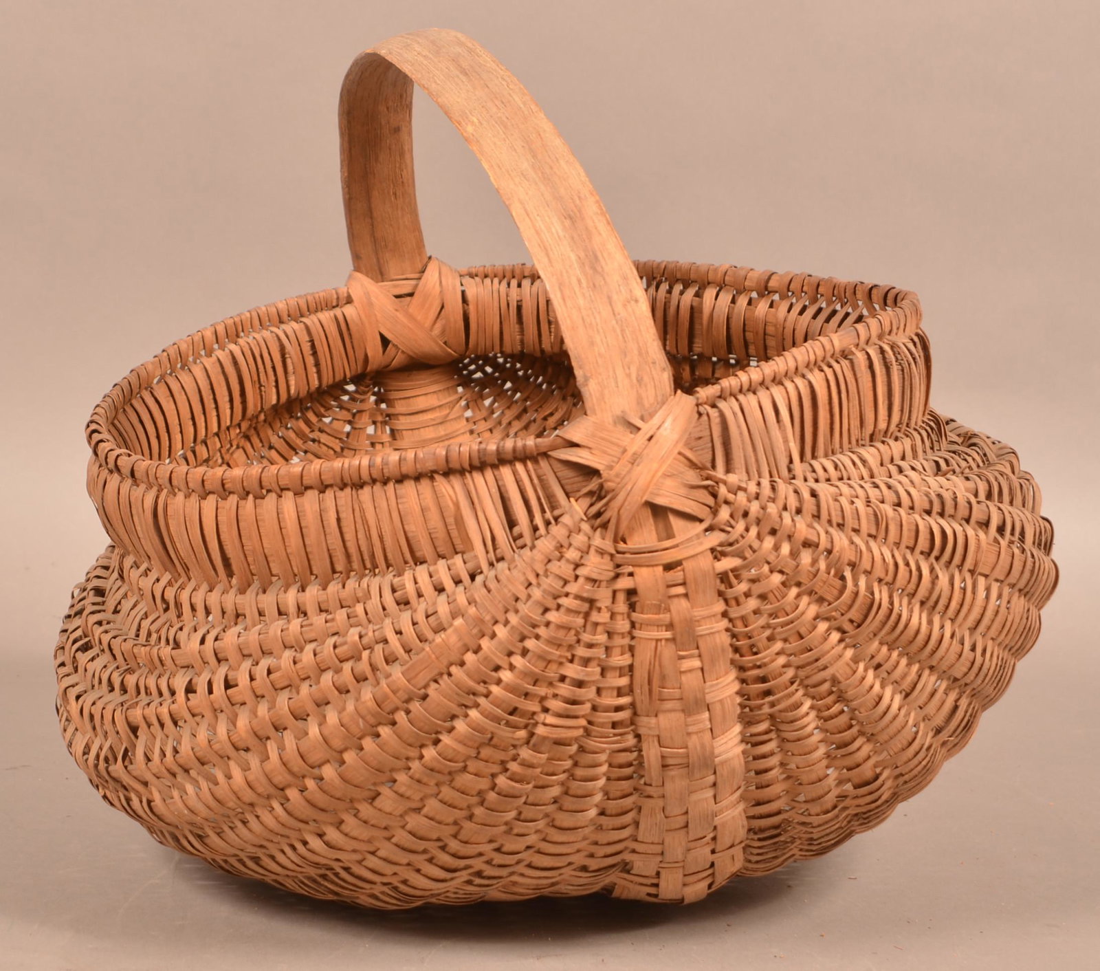 Antique Woven Oak Splint Market Basket.: Antique Woven Oak Splint Market Basket. Rib type with bentwood handle, double bentwood wrapped rim and bulbous sides. 12"h. x 15"w. Condition: Good with some breaks and losses.