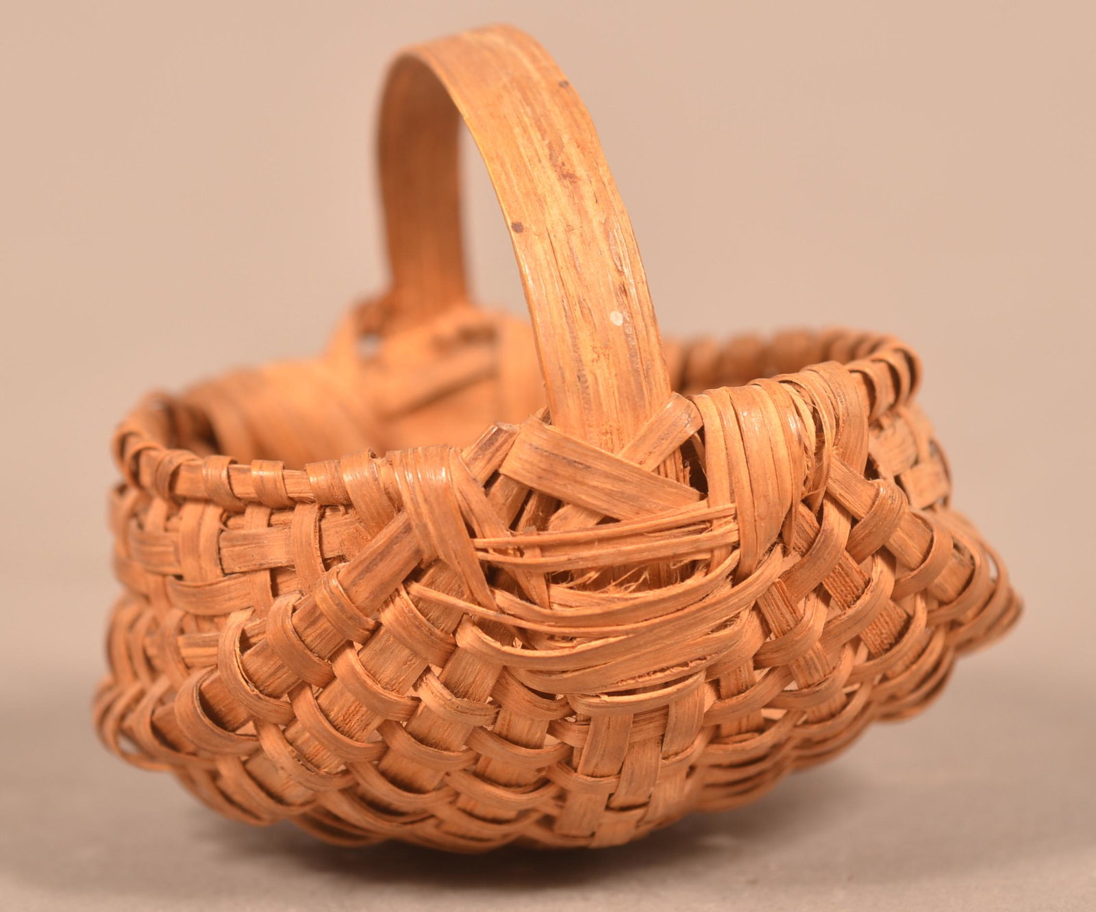 Pennsylvania Miniature Woven Splint Basket.: Pennsylvania Miniature Woven Splint Basket. Rib type with bentwood handle and bentwood wrapped rim. 2-1/4"h. x 2-3/4"w. Condition: Very good with minor wear.