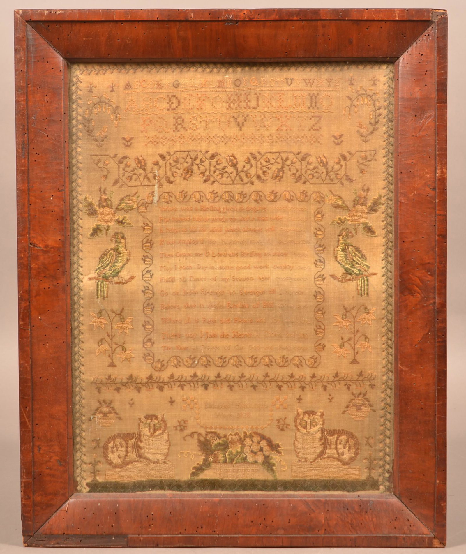 Elizabeth Hemming 1828 Needlework Verse Sampler.: Elizabeth Hemming 1828 Needlework Verse Sampler. Mirror image with cats, parrots and floral motif. In a period mahogany frame, 21" x 16-3/4" overall. Condition: Good with foxing and minor loss. Frame 