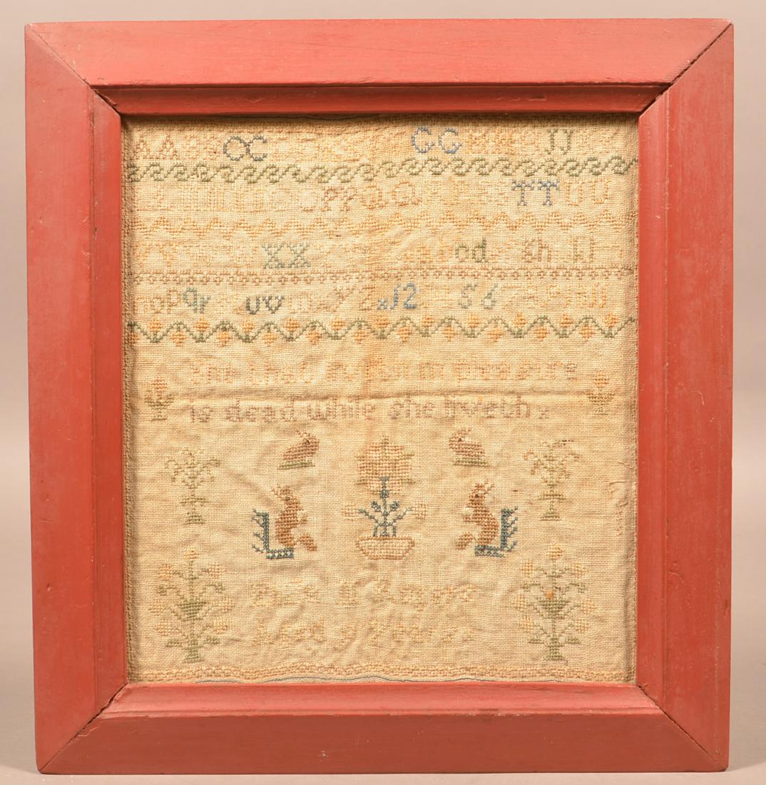 19th Century Cross Stitch Alphabet Sampler.: 19th Century Cross Stitch Alphabet Sampler. "Eliza M. Rogers, Aged 9 Years". Rowed type with rabbits, squirrels and floral devices. In a red molded frame, 15-1/2" x 14-1/2" overall. Condition: Good wi