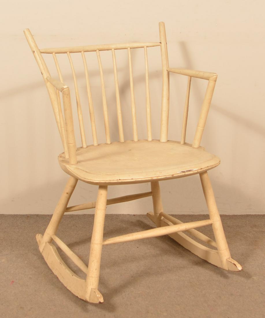 Bamboo-Turned Windsor Rocking Chair Painted White.: Bamboo-Turned Windsor Rocking Chair Painted White. Seven spindle-back, shield shaped seat, duckbill arms and cheese cutter rockers. Seat height 16", 31"h. overall. Condition: Good with wear.