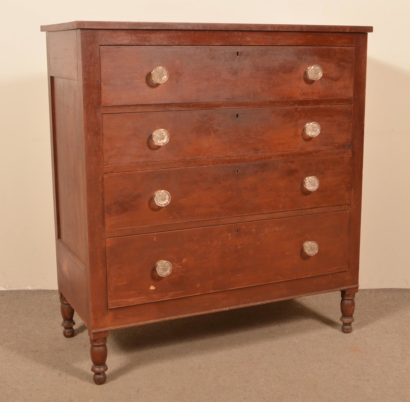 Pennsylvania Federal Cherry Chest of Drawers.: Pennsylvania Federal Cherry Chest of Drawers. Four graduated full-width dovetailed drawers with the original colorless sandwich glass floral rosette pulls, paneled sides and turned feet. Original red 