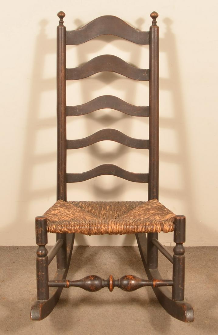 Delaware Valley Five Slat Ladderback Rocking Chair.: Chester County, PA Five Slat Ladderback Rocking Chair. Late 18th/Early 19th century, rush seat, retaining an old varnished surface. Seat height 15", 38"h. overall. Condition: Good with wear.