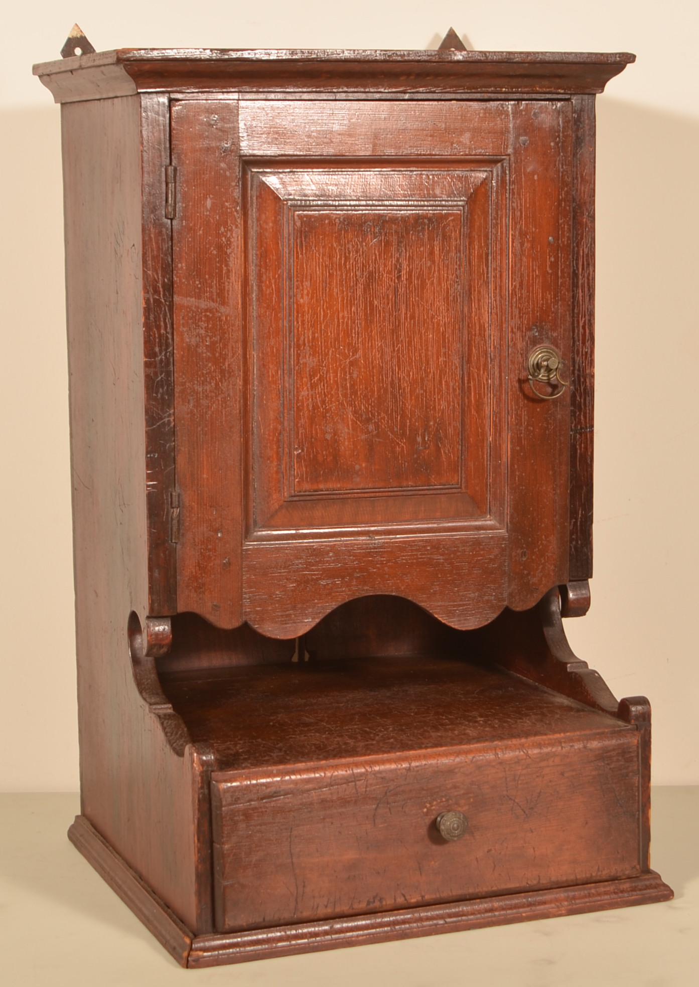 Late 18th/Early 19th Century Hanging Cupboard.: Late 18th/Early 19th Century Mixedwood Hanging Cupboard. Ogee molded cornice, raised panel door, stepped open shelf with lower full width dovetailed drawer and molded base trim. 30"h. x 19-1/4"w. x 17