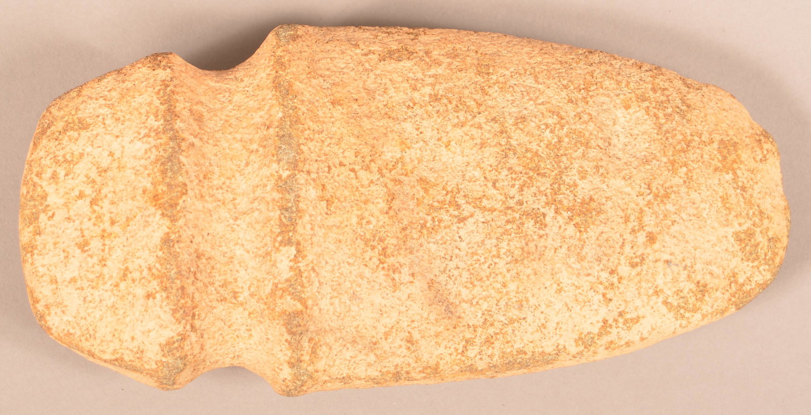 An Ancient Full Groove Stone Axe Head.: An Ancient Full Groove Stone Axe Head, 9 1/2" x 4 1/2". Condition: Good.