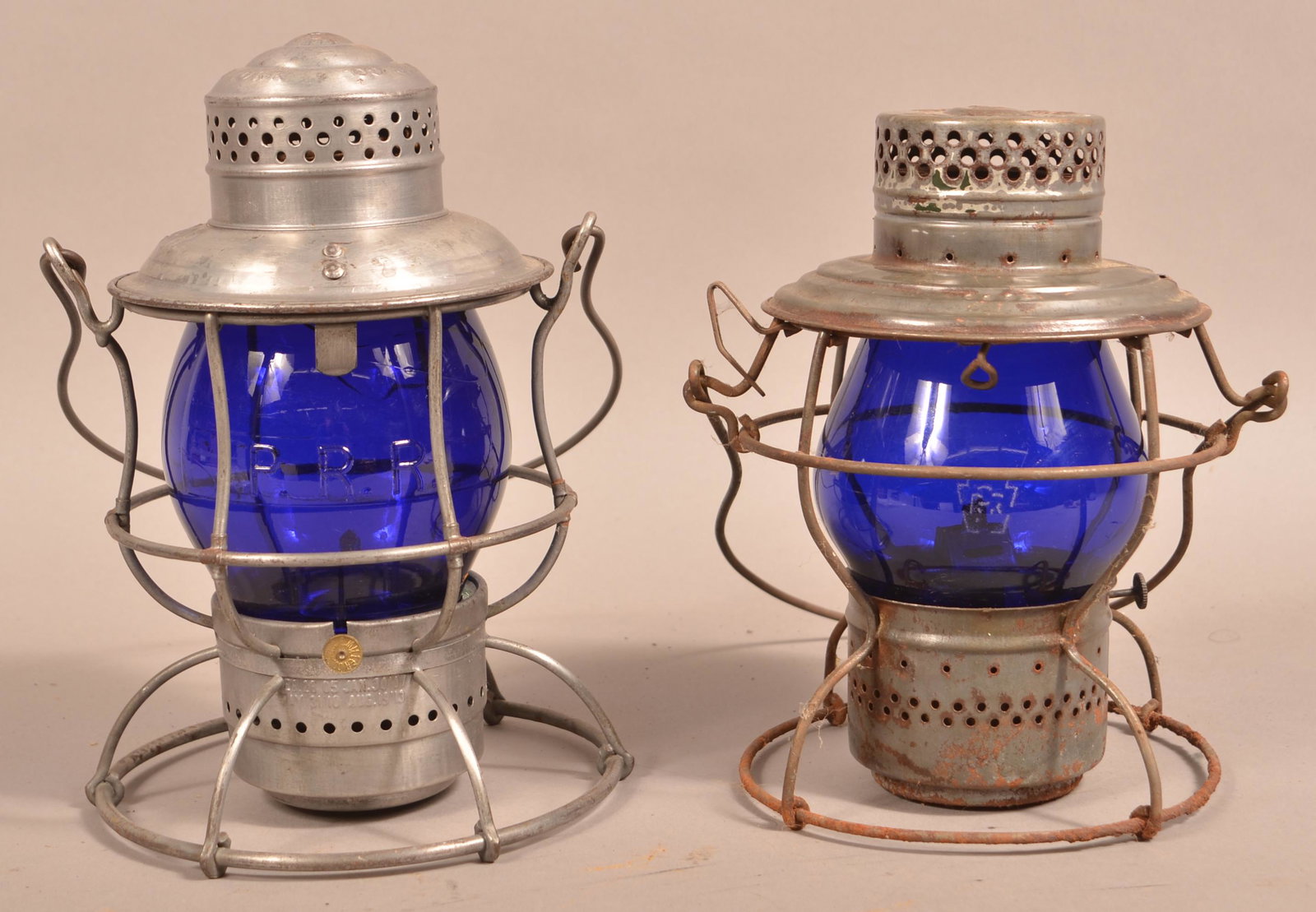 Two Vintage Pennsylvania Railroad Lanterns.: Two Vintage Pennsylvania Railroad Lanterns. Both with blue glass globes. Handlan and Armspear 9"h. and 10-1/2"h., not including handle. Condition: Good with use wear and light rust. Armspear lantern h