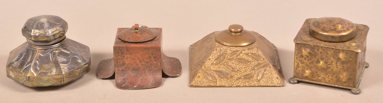 Four Early 20th Century Metal Inkwells.: Four Early 20th Century Metal Inkwells. Arts and Crafts and Art Nouveau period. Including Apollo Studios, NY, and Deknatel Copyright 1910. Largest measures 3-1/4"w. Condition: Good with wear and repai