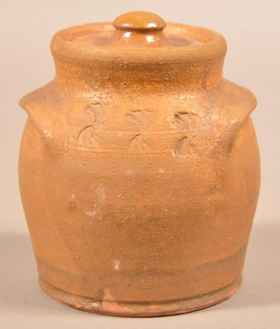 Henry Schofield Glazed Redware Covered Honey Pot.: Henry Schofield Glazed Redware Covered Honey Pot. Unsigned, attributed to Henry Schofield, Cecil County, MD, early 20th century. Unusual matt glaze, bulbous form with stamped flourishes and lug handle