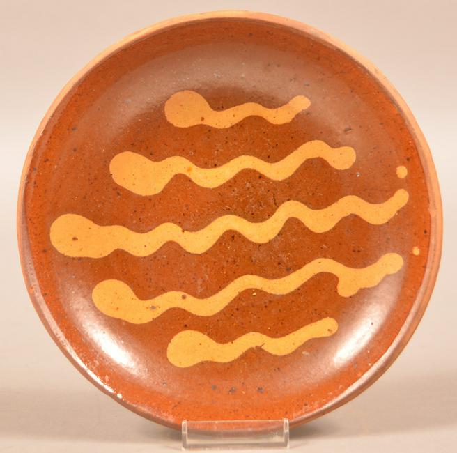 19th Century Slip Decorated Redware Plate.: 19th Century Slip Decorated Redware Plate. Unsigned, attributed to Willoughby Smith, Berks County, PA, Circa. 1865-1880. 8"diam. Condition: Very good with a few tiny edge chips.