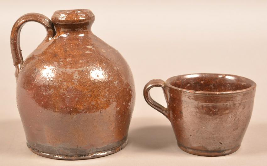 Henry Schofield Glazed Redware Jug and Mug.: Henry Schofield Glazed Redware Jug and Mug. Unsigned, attributed to Henry Schofield, Cecil County, MD, early 20th century. Two-tone glaze with applied handles. 3" and 6"h. Condition: Very good with a