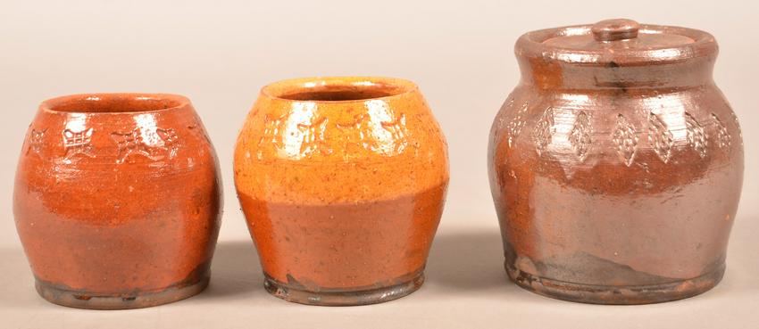 Three Pieces of Henry Schofield Glazed Redware.: Three Pieces of Henry Schofield Glazed Redware. Unsigned, attributed to Henry Schofield, Cecil County, MD, early 20th century. Glazed, bulbous forms with stamped geometric designs. Covered sugar measu