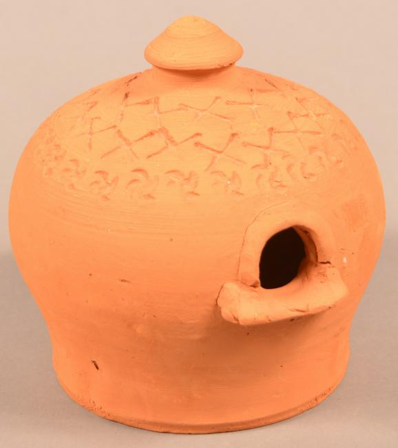 Redware Birdhouse Attributed to Henry Schofield.: Redware Birdhouse Attributed to Henry Schofield. Cecil County, MD. Early 20th century. Unglazed, dome form with stamped decoration. 6-1/4"h. Condition: Good with a chip on the hanging finial.