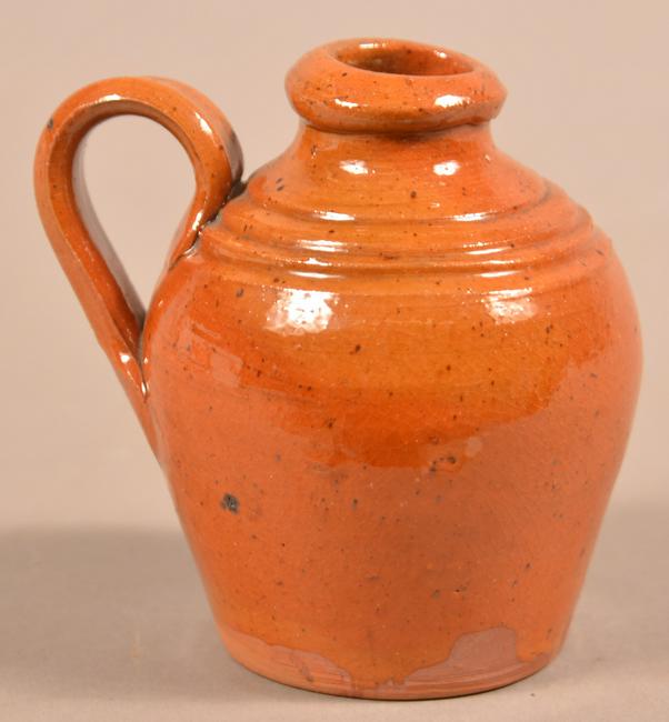 Antique Glazed Redware Miniature Jug.: Antique Glazed Redware Miniature Jug. Bulbous form with applied handle and tooled shoulder. 3-1/2"h. Condition: Very good.