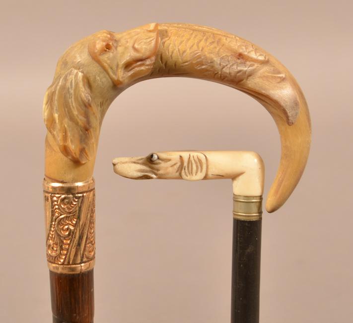 Two Antique Folk Art Carved Handle Canes.: Two Antique Folk Art Carved Handle Canes. Horn handle with carved dog and eagle heads, 36-1/2"l. and carved bone dog head, 35"l. Condition: Good with minor wear.