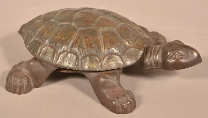 Antique Figural Cast Iron Turtle Spittoon.: Antique Figural Cast Iron Turtle Spittoon. Pressing the turtle's head down lifts the shell to reveal the interior pan. 14"l. Condition: Good with minor wear.