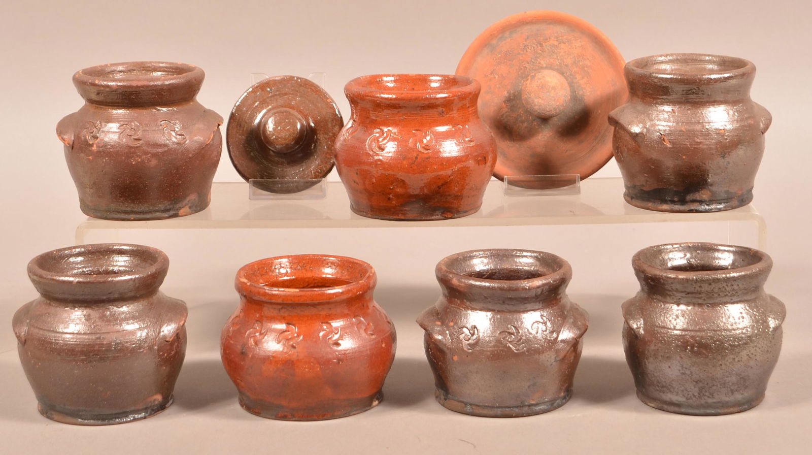Lot of Redware Pottery Attributed to Schofield.: Lot of Redware Pottery Attributed to Schofield. Seven sugar bowls (no lids); Two Schofield lids. Tallest measures 3-3/4"h. Condition: Good with chips and wear.