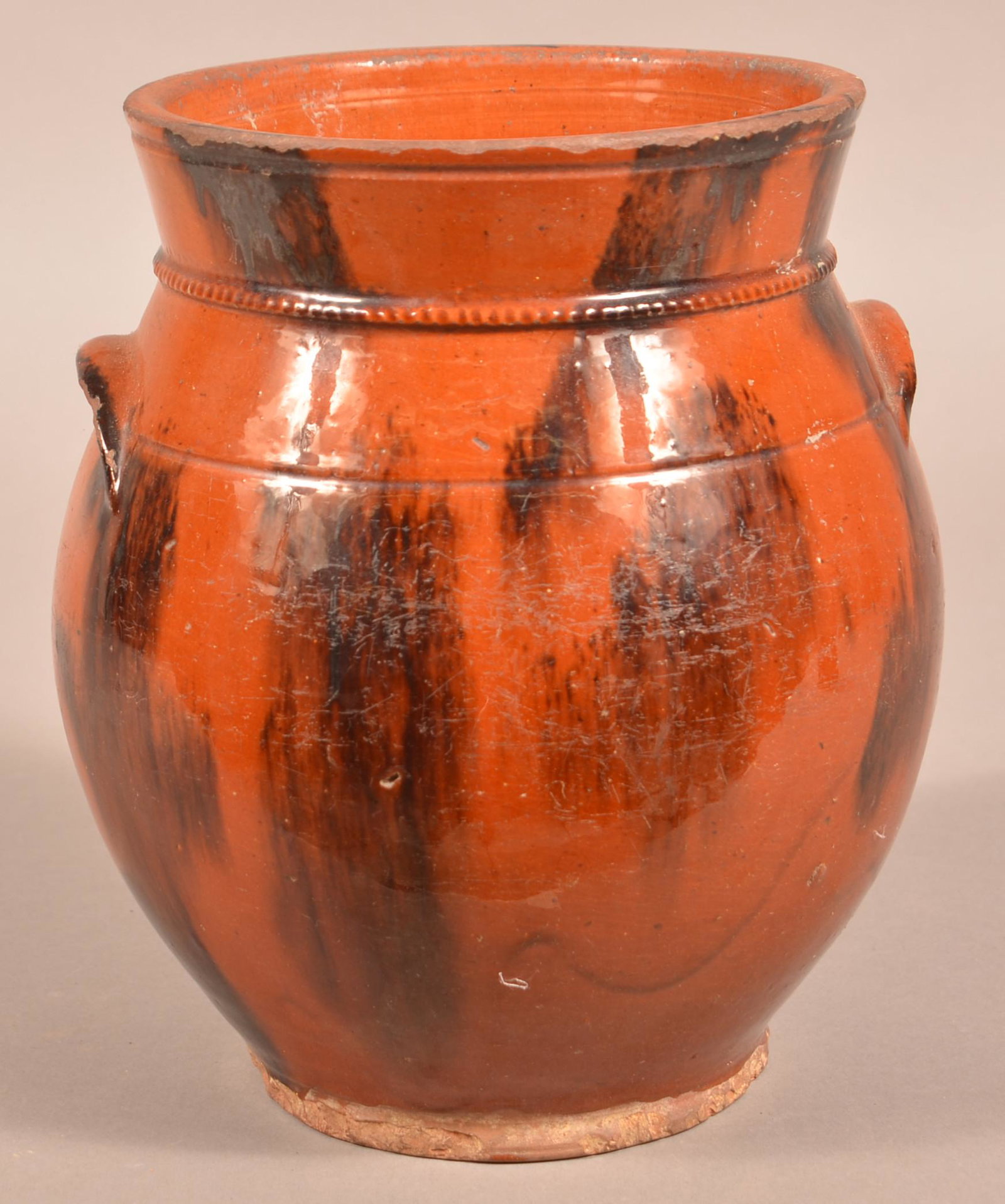 19th Century Mottle Glazed Redware Jar.: 19th Century Mottle Glazed Redware Jar. 10-1/4"h. Condition: Fair with numerous base rim chips and glaze wear.
