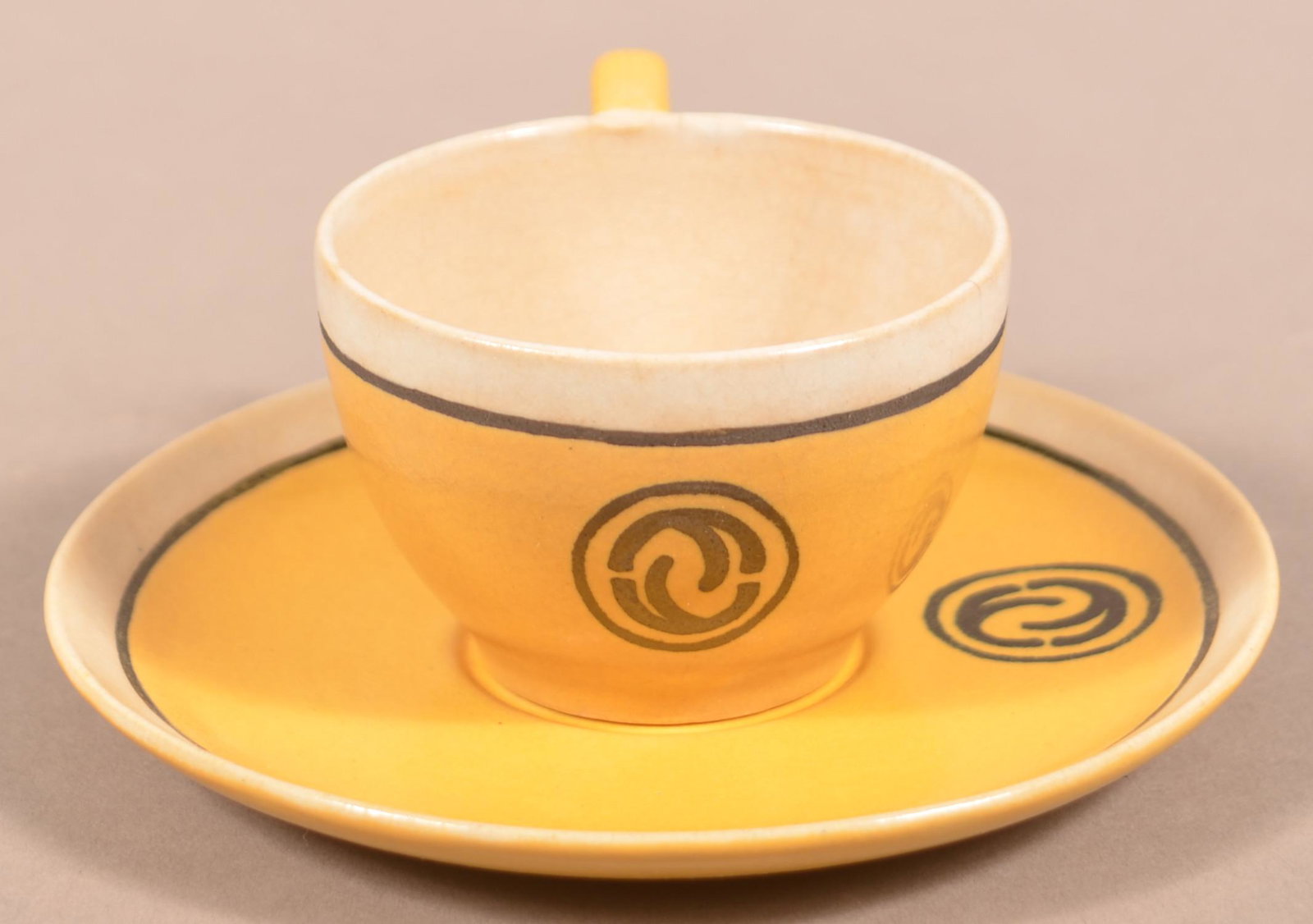 Saturday Evening Girls Paul Revere Pottery Cup & Saucer: Saturday Evening Girls (SEG) Paul Revere Pottery Cup and Saucer. Marked SEG 10-14 and 11-14 with the decorator's initials "FL". Saucer measures 5-1/4" diam. Condition: Good with a small spider line on