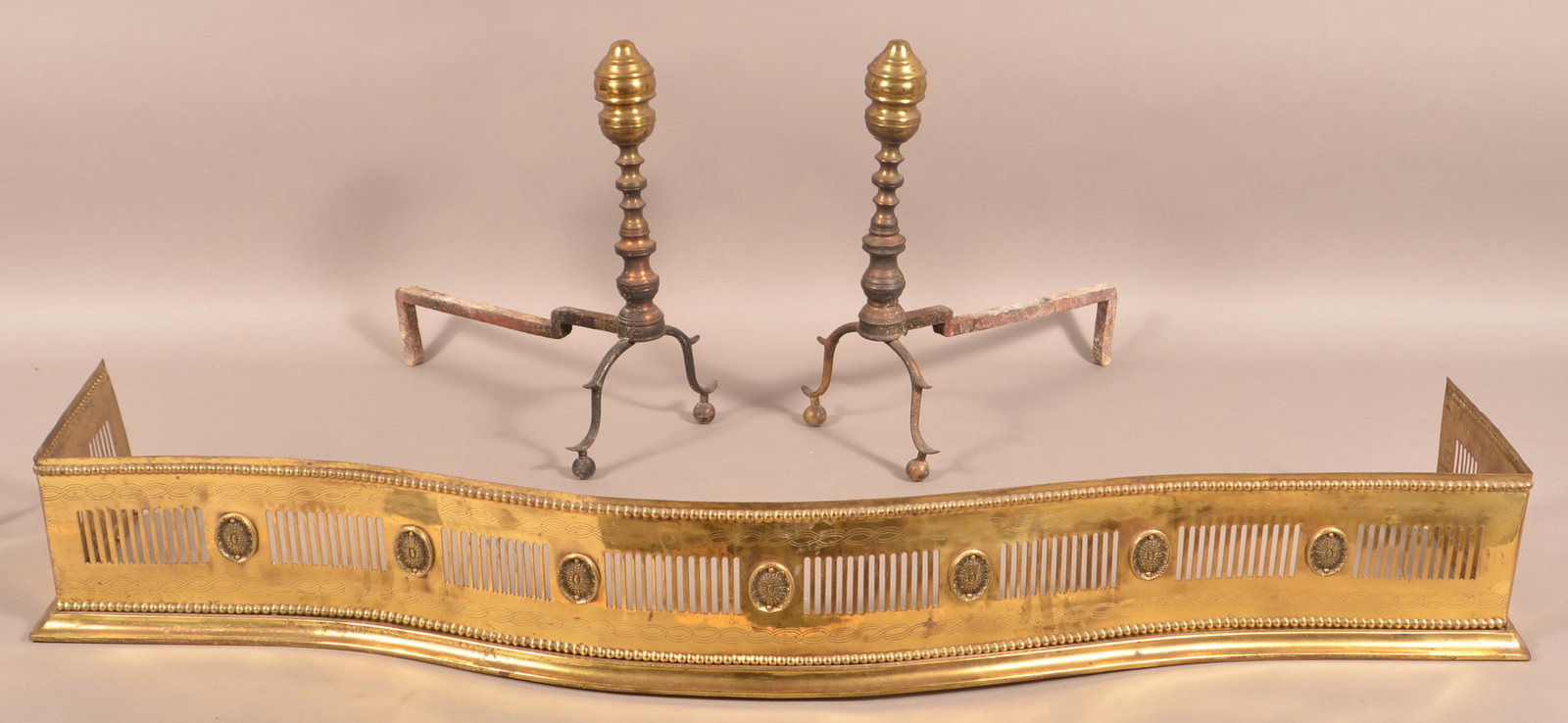 Pair of Antique Brass Andirons and Fireplace Fender.: Pair of Antique Brass Andirons and Fireplace Fender. Andirons 17"h.; Fender measures 49-1/2"w. Tex Johnson Collection. Condition: Good with wear and some cracks.