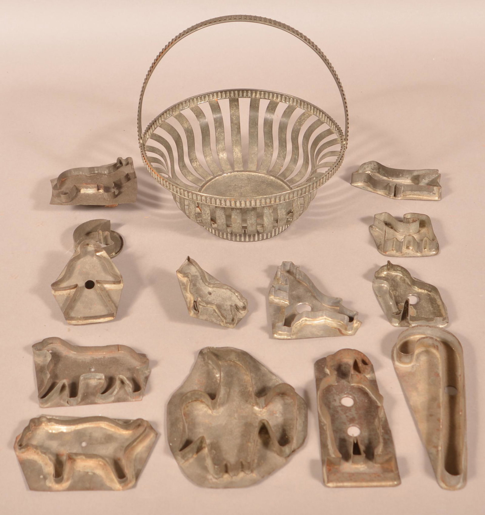 Antique Tin Basket and 13 Figural Cookie Cutters.: Antique Tin Basket and 13 Figural Cookie Cutters. Basket measures 10-1/4"h. Condition: Good with minor dents and wear.