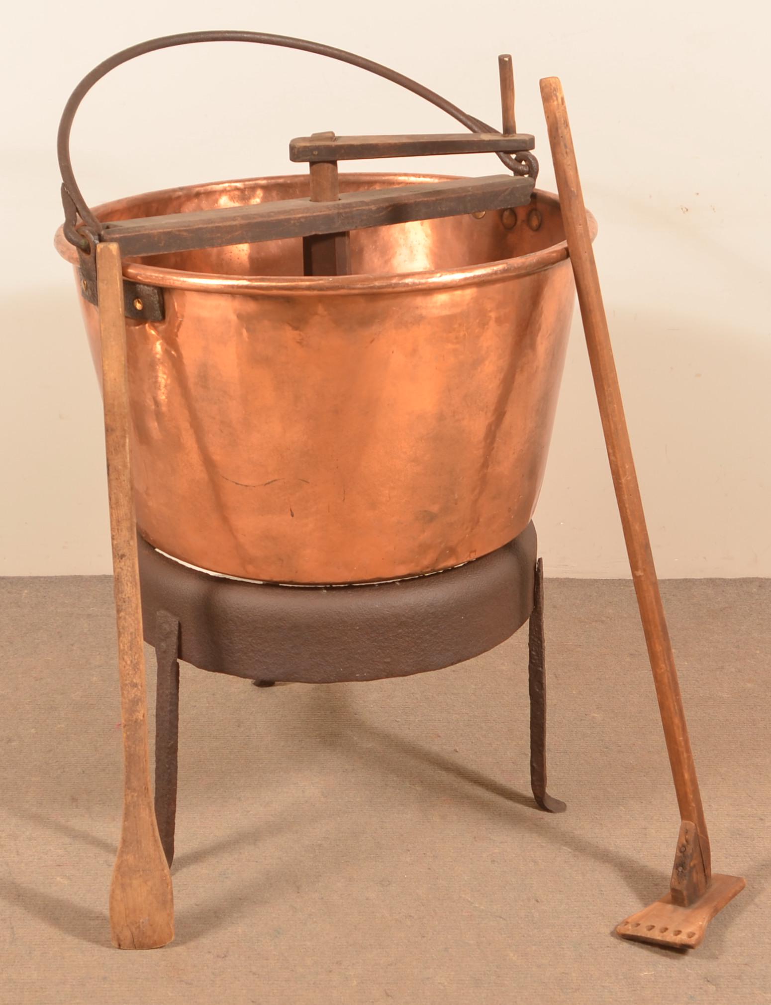 19th Century Copper Apple Butter Kettle.: 19th Century Copper Apple Butter Kettle. With wood crank stirrer and iron stand. 19"h. x 29" diam. Condition: Good with dents and wear.
