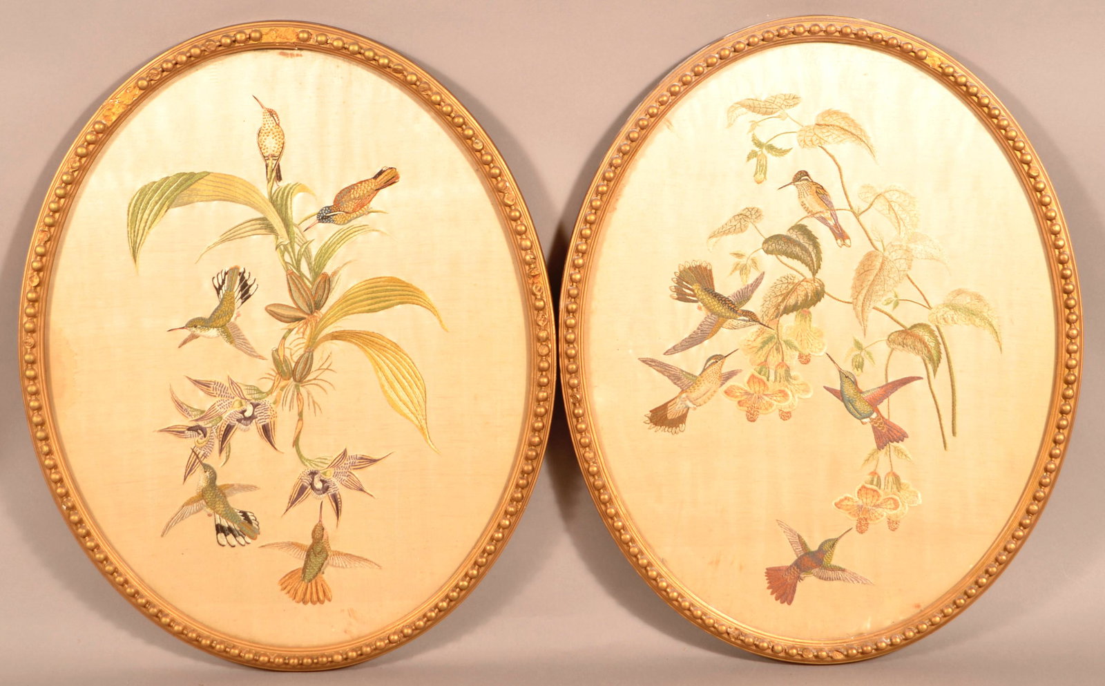 Pair of Antique Silk Thread Needleworks.: Pair of Antique Humming Bird and Flower Silk Thread Needleworks. Oval gilt frames, 22" x 18" overall. Tex Johnson Collection. Condition: Good with some foxing and staining, frames have some loss.