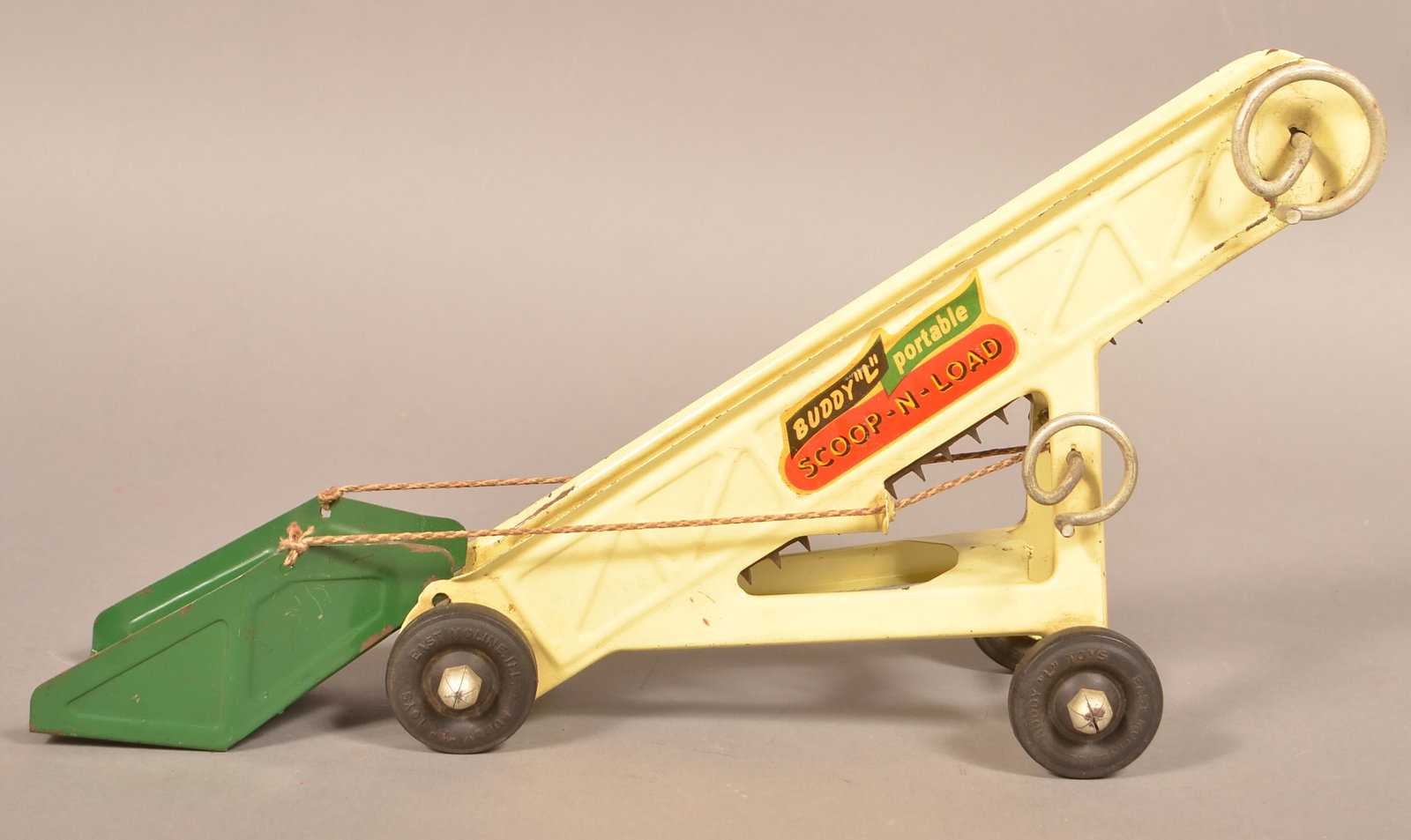 Buddy L Pressed Steel "Portable Scoop-N-Load".: Buddy L Pressed Steel "Portable Scoop-N-Load". Has green scoop, yellow body, and 4 Buddy L rubber tires. Condition: Good to very good with minor wear.