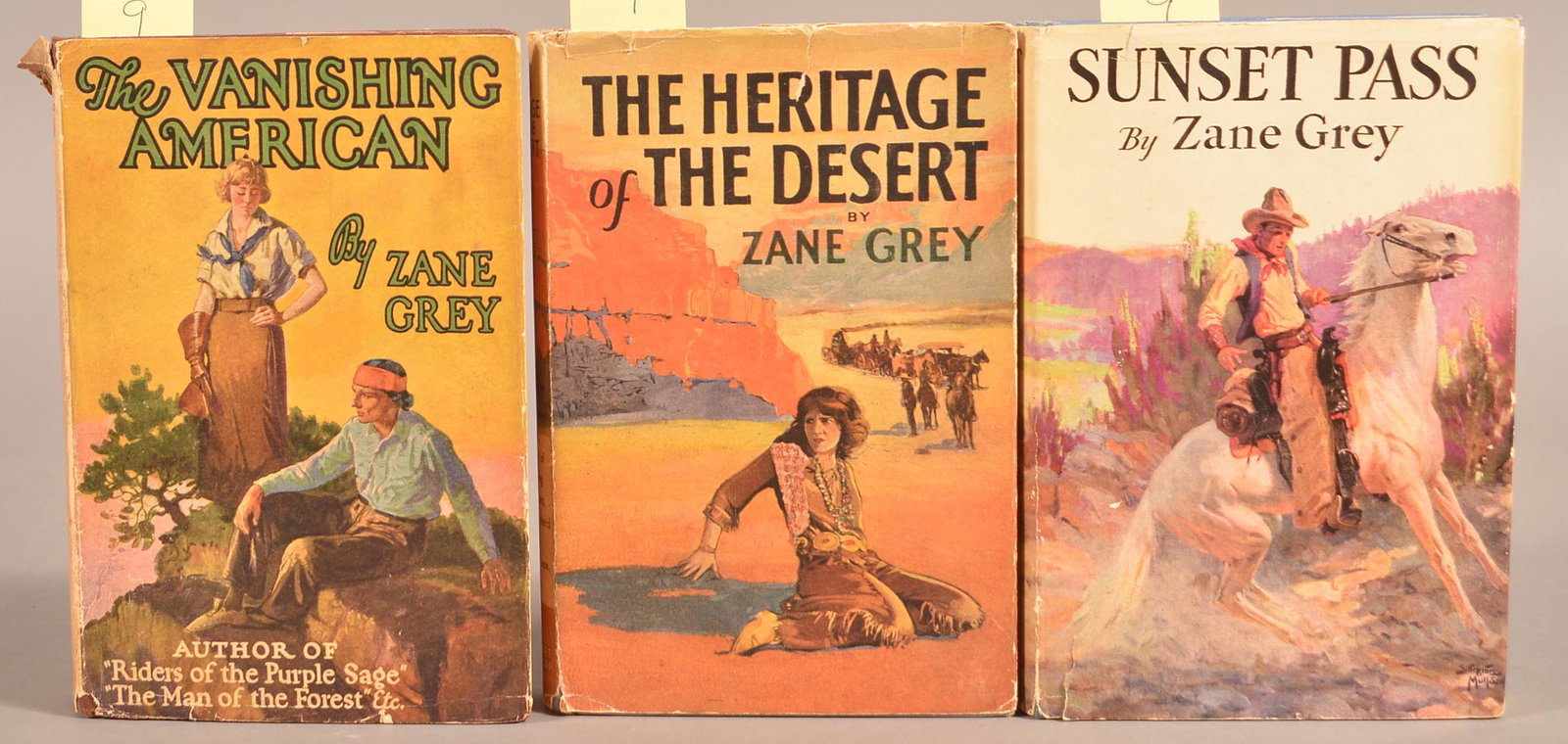 Zane Grey 3 Volumes Incl Vanishing American: Three volumes by Zane Grey, all published by Grosset & Dunlap, all in dust jackets, including: The Vanishing American (1925), The Heritage of the Desert (1910), Sunset Pass (1931). Condition: Very Goo