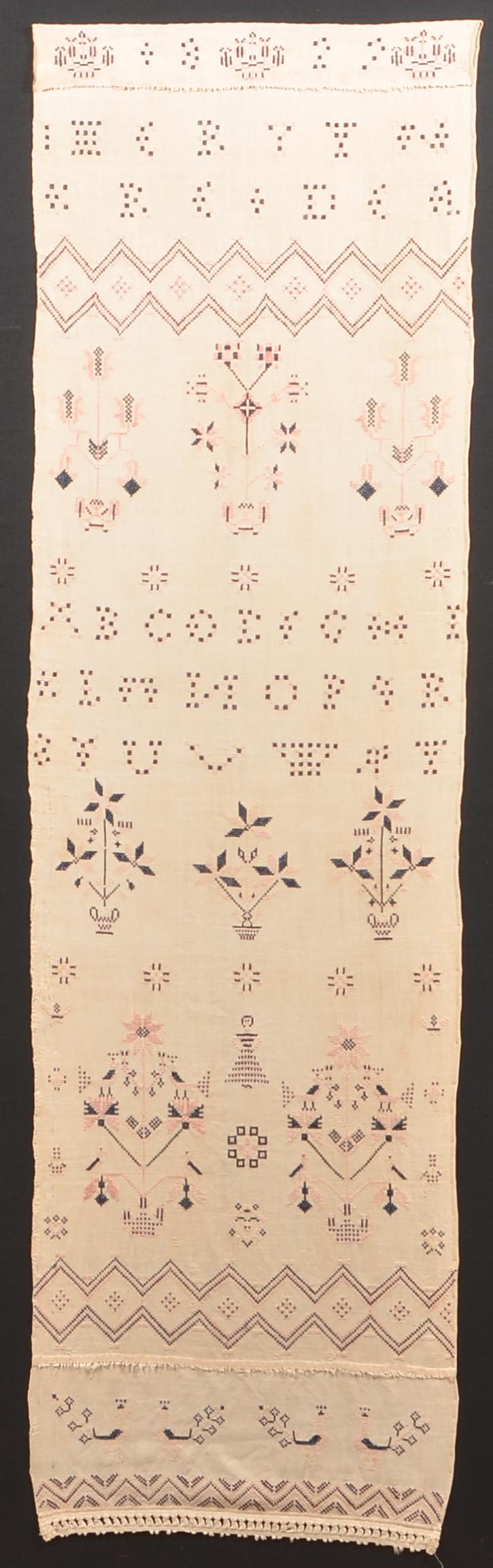 1829 Cross Stitch Show Towel, Signed Imeryyn Kreider.: 1829 Cross Stitch Show Towel, Signed Imeryyn Kreider. 63" x 18", mounted on a backing board. Condition: Good with toning.