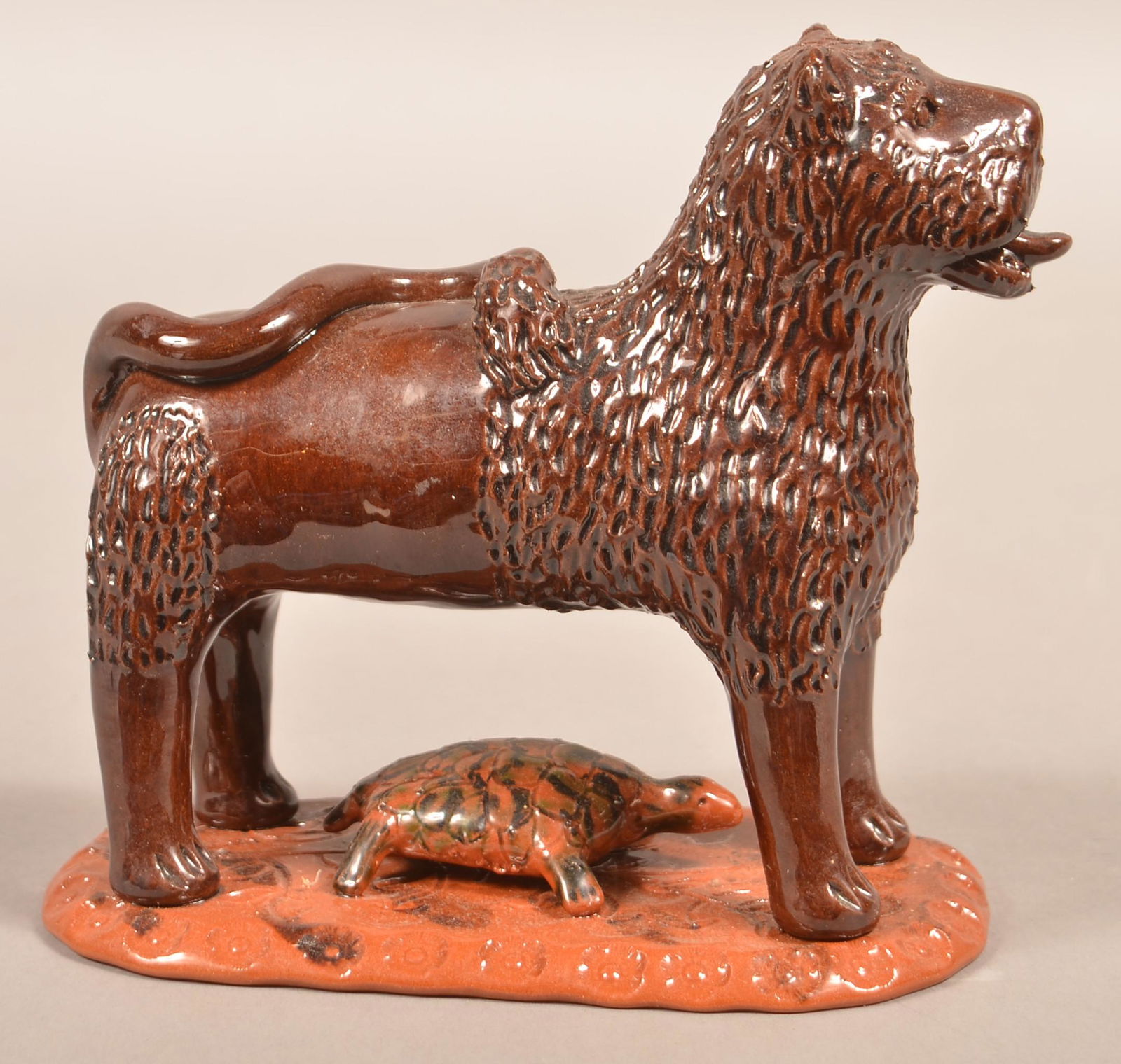 Breininger Glazed Redware Lion and Turtle Figure.: Breininger Glazed Redware Lion and Turtle. A lion sticking his tongue out of his mouth and standing over a turtle. Marked: Breininger Pottery Robesonia, PA March 2002. 7"h. Condition: Very good.