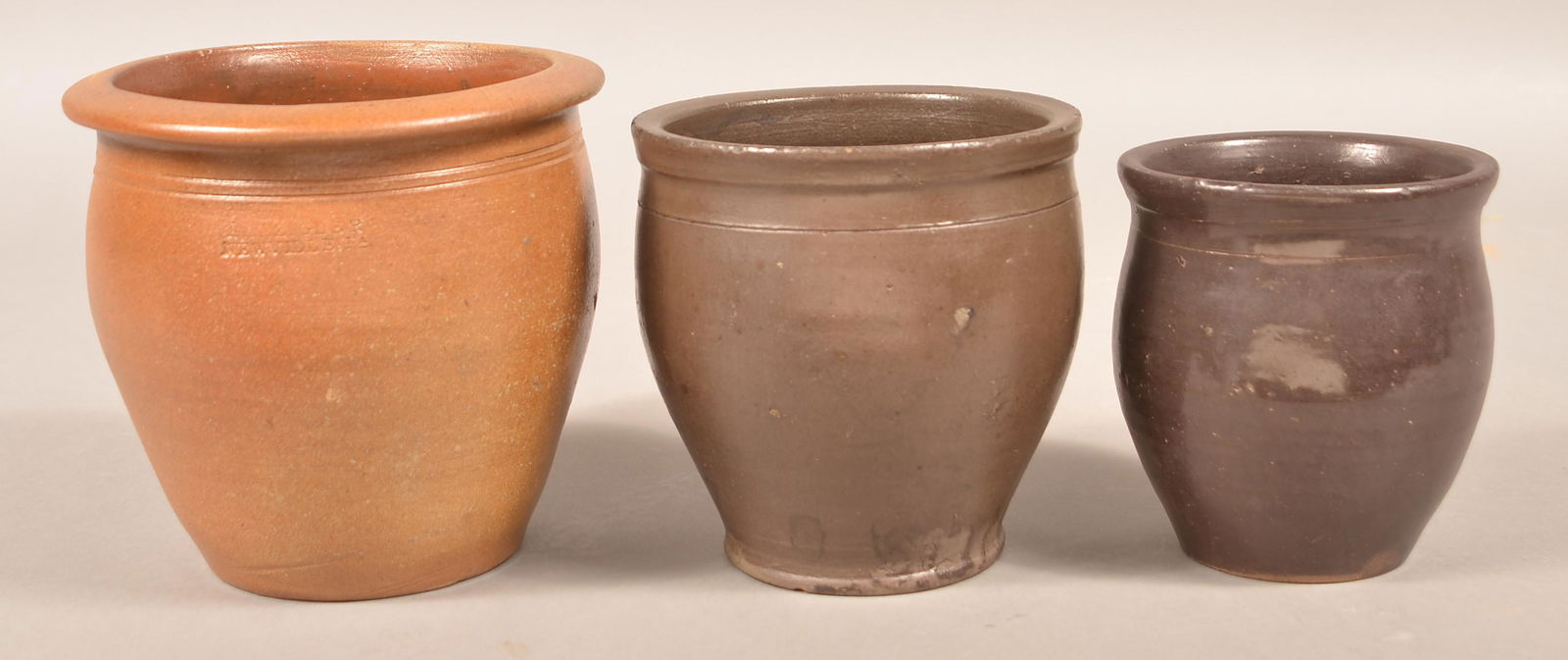 Three H.H. Zigler, Newville, PA Stoneware Storage Jars.: Three H.H. Zigler, Newville, PA Stoneware Storage Jars. Two stamped on base, one stamped on collar, circa 1852-1865. Various glazes. Largest measures 7"h. Condition: Very good.