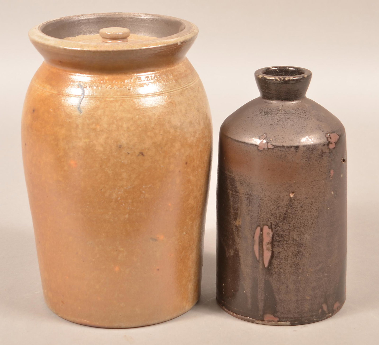 Two H.H. Zigler, Newville, PA Earthenware Storage Jars.: Two H.H. Zigler, Newville, PA Earthenware Storage Jars. One stamped on base, one stamped on shoulder, circa 1852-1865. Various glazes. Largest measures 7"h. Condition: Good. Larger has a chip on lid.