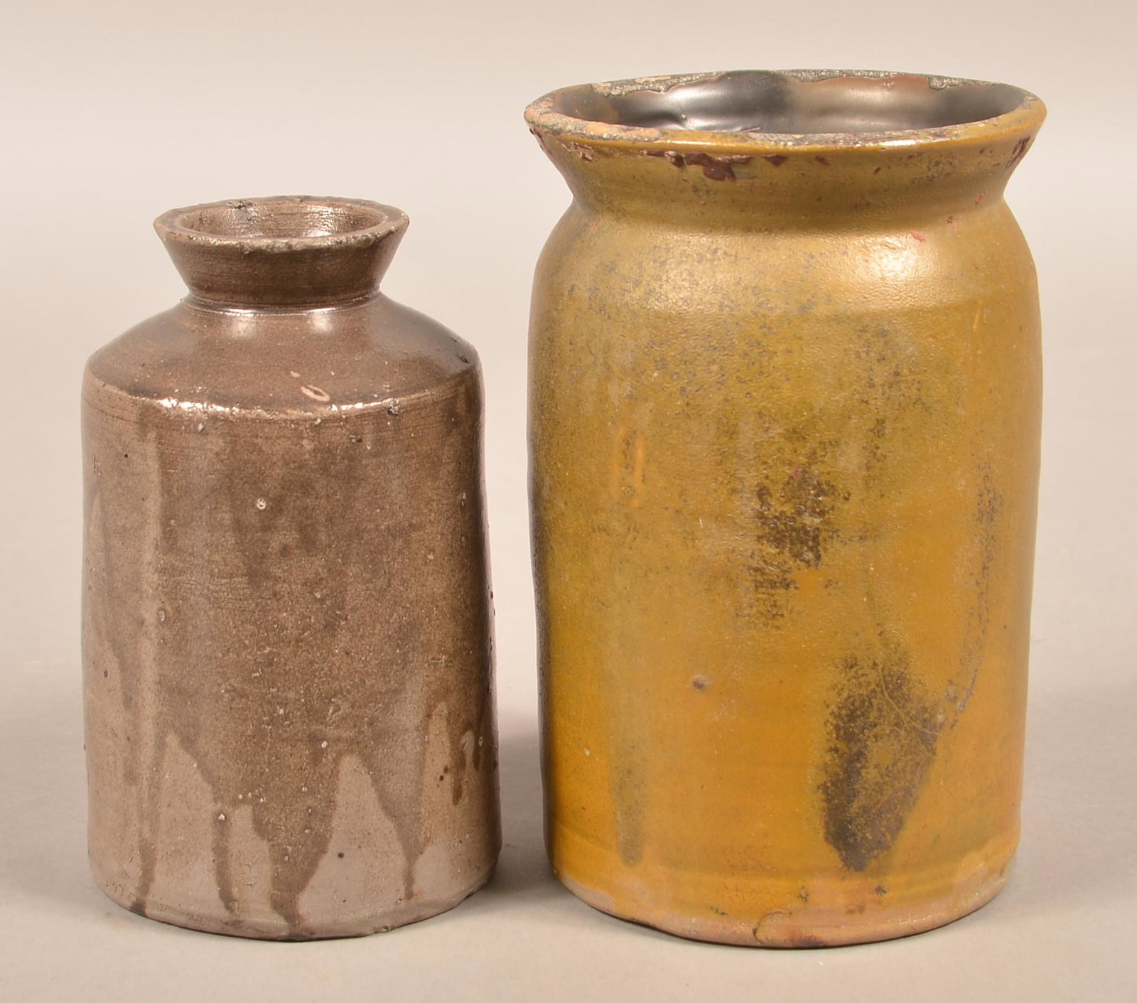 Two H.H. Zigler, Newville, PA Earthenware Storage Jars.: Two H.H. Zigler, Newville, PA Earthenware Storage Jars. Circa 1852-1865. Both stamped on base. Various glaze. Largest measures 8-1/2"h. Condition: Good with minor rim chips.