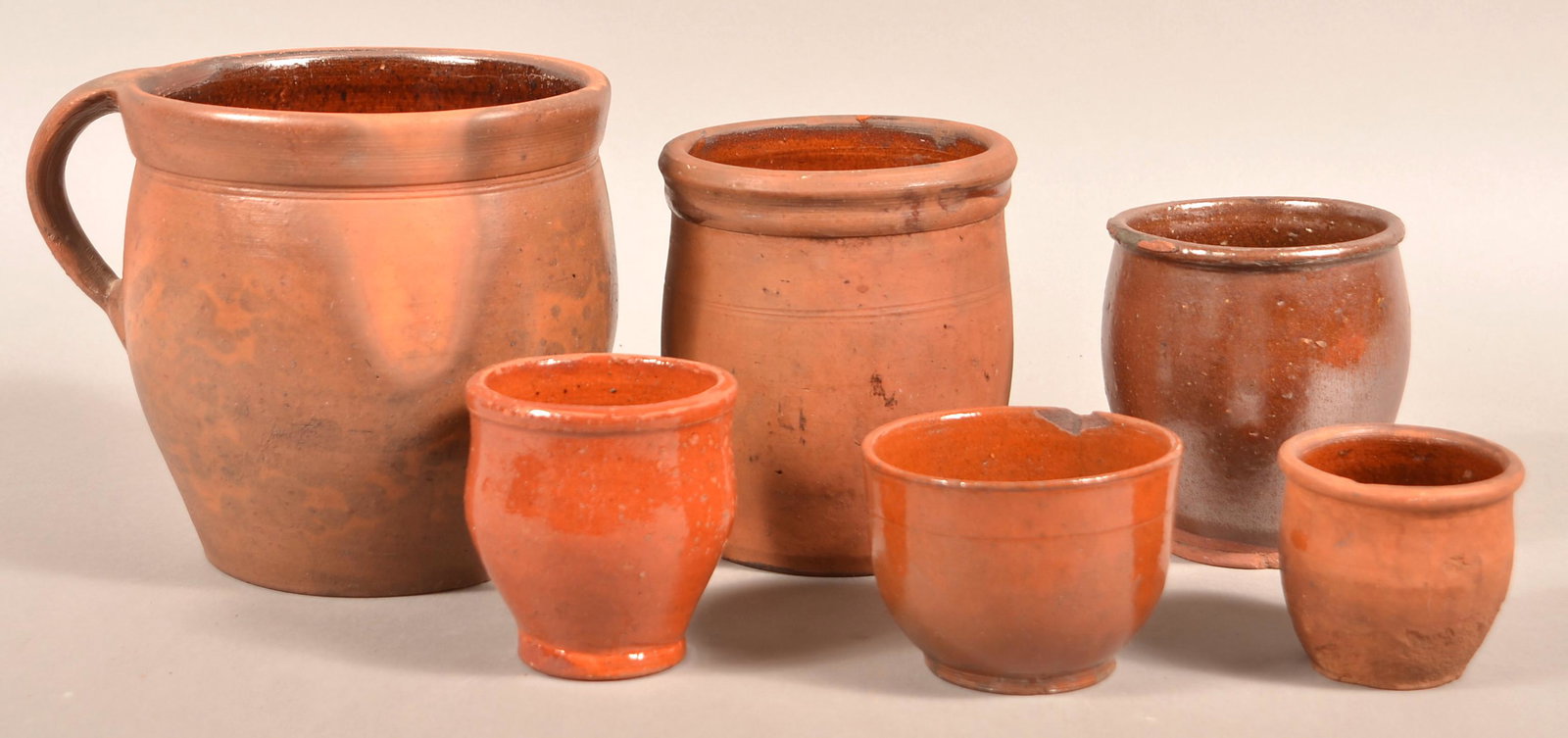 Six Antique Glazed Redware Storage Crocks.: Six Antique Glazed Redware Storage Crocks. Largest 7-3/4"h. Condition: Good with chips and lines.