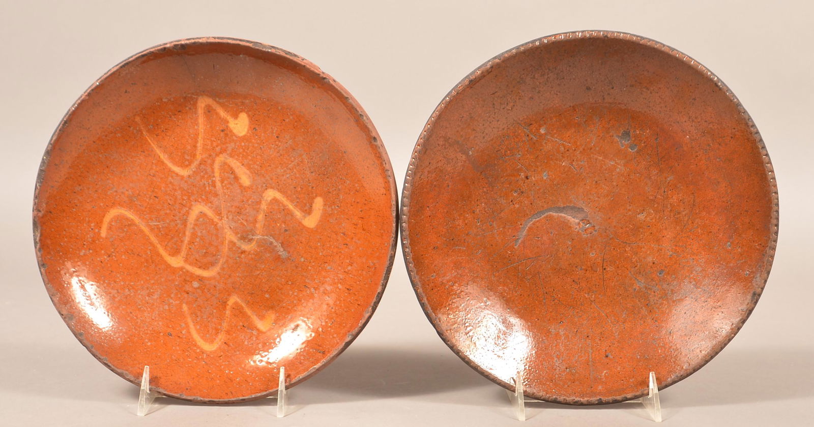 Two 19th Century Glazed Redware Plates.: Two 19th Century Glazed Redware Plates. Largest 10-1/2" diam. Condition: Good with chips and wear.