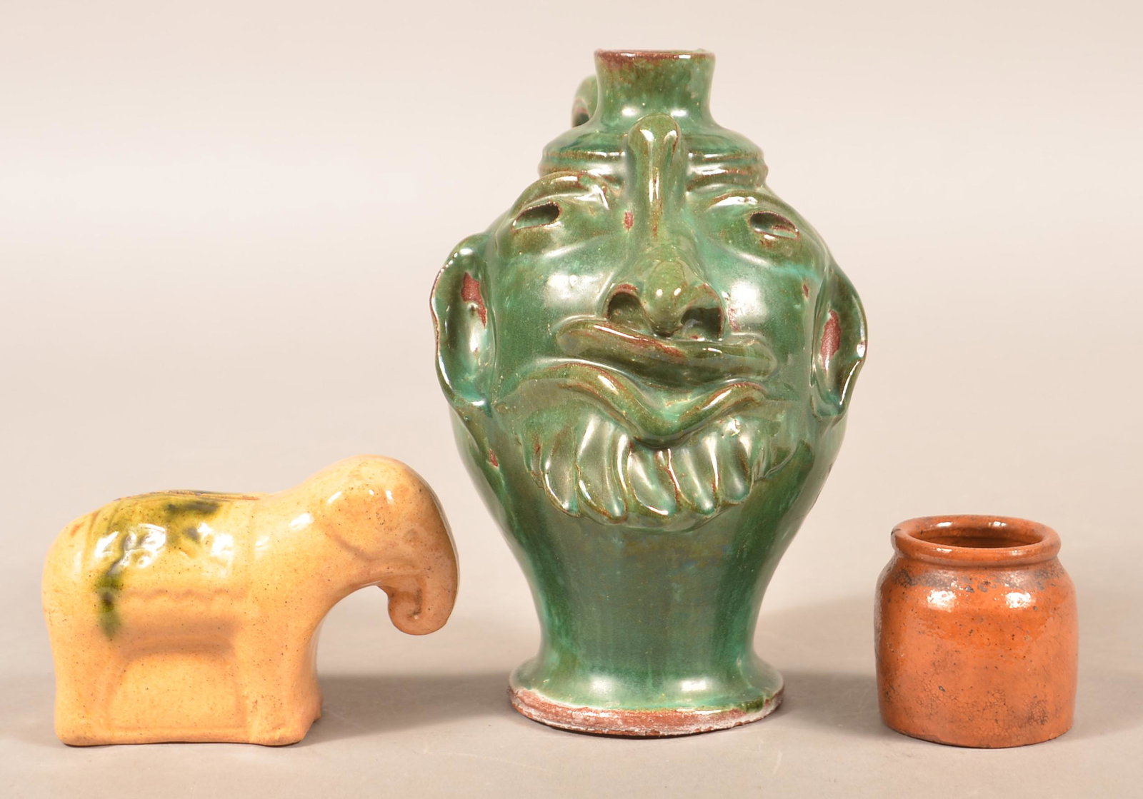 Three Pieces of Glazed Earthenware.: Three Pieces of Glazed Earthenware. Largest 6-3/4"h. Condition: Good, face jug has a handle repair.