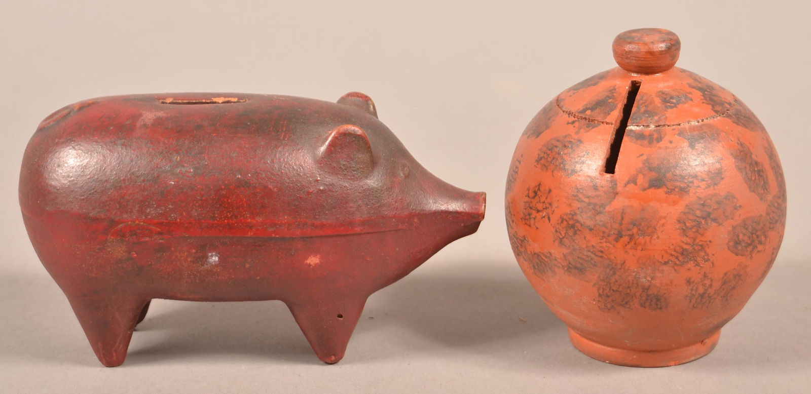 Two Antique Redware Still Banks.: Two Antique Redware Still Banks. Dome bank with manganese sponge decoration, 3-1/2"h. and a pig form bank, 6"l. Condition: Very good with a few tiny chips.