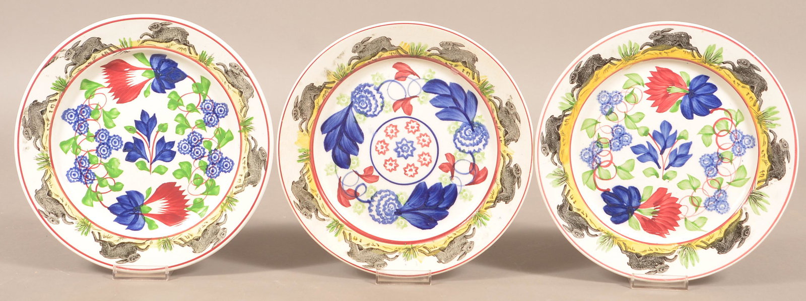 Three Rabbitware Stick Spatter Ironstone China Plates.: Three Rabbitware Stick Spatter Ironstone China Plates. Various polychrome stick spatter centers with rabbit borders. 9-3/8" diam. Condition: Two are very good, one with hairline.
