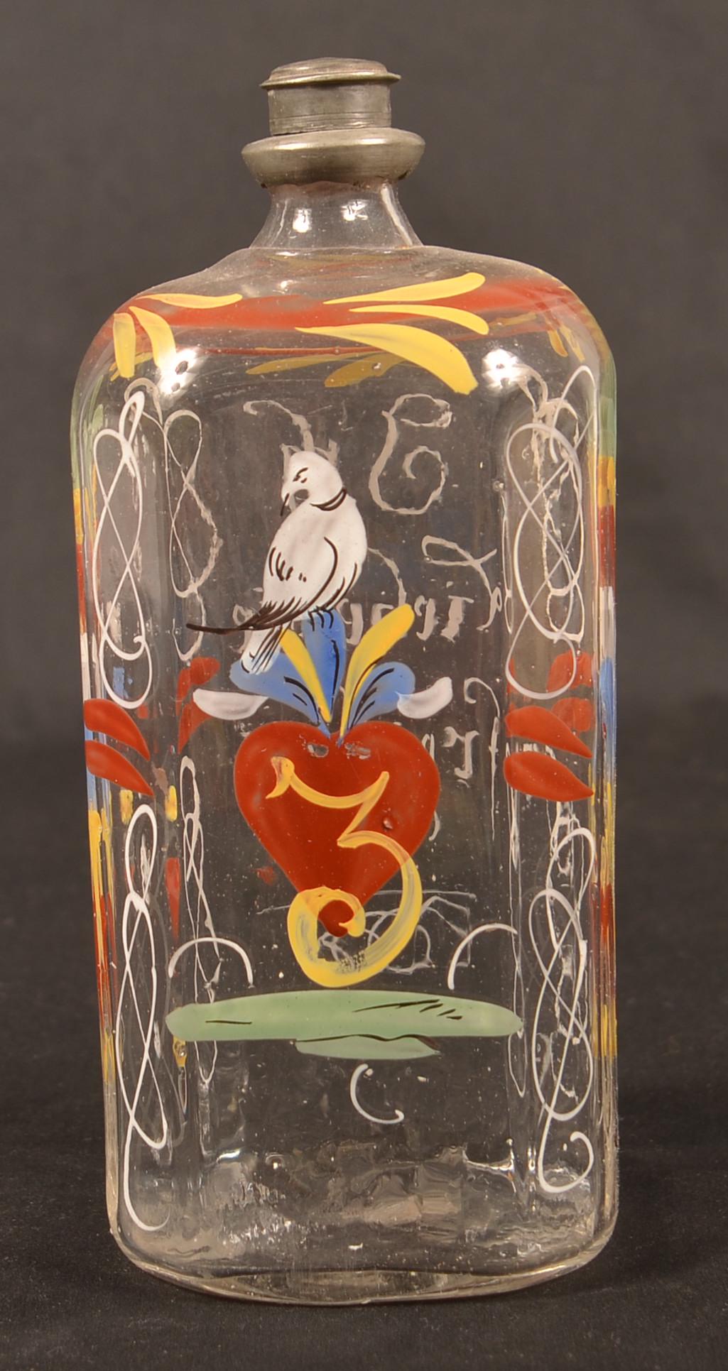 Stiegel Type Enamel Decorated Glass Cologne Bottle.: Stiegel Type Polychrome Enamel Decorated Colorless Glass Cologne Bottle. Bird, heart, floral and foliate decoration. 6-3/4"h. Condition: Very good with minor loss.