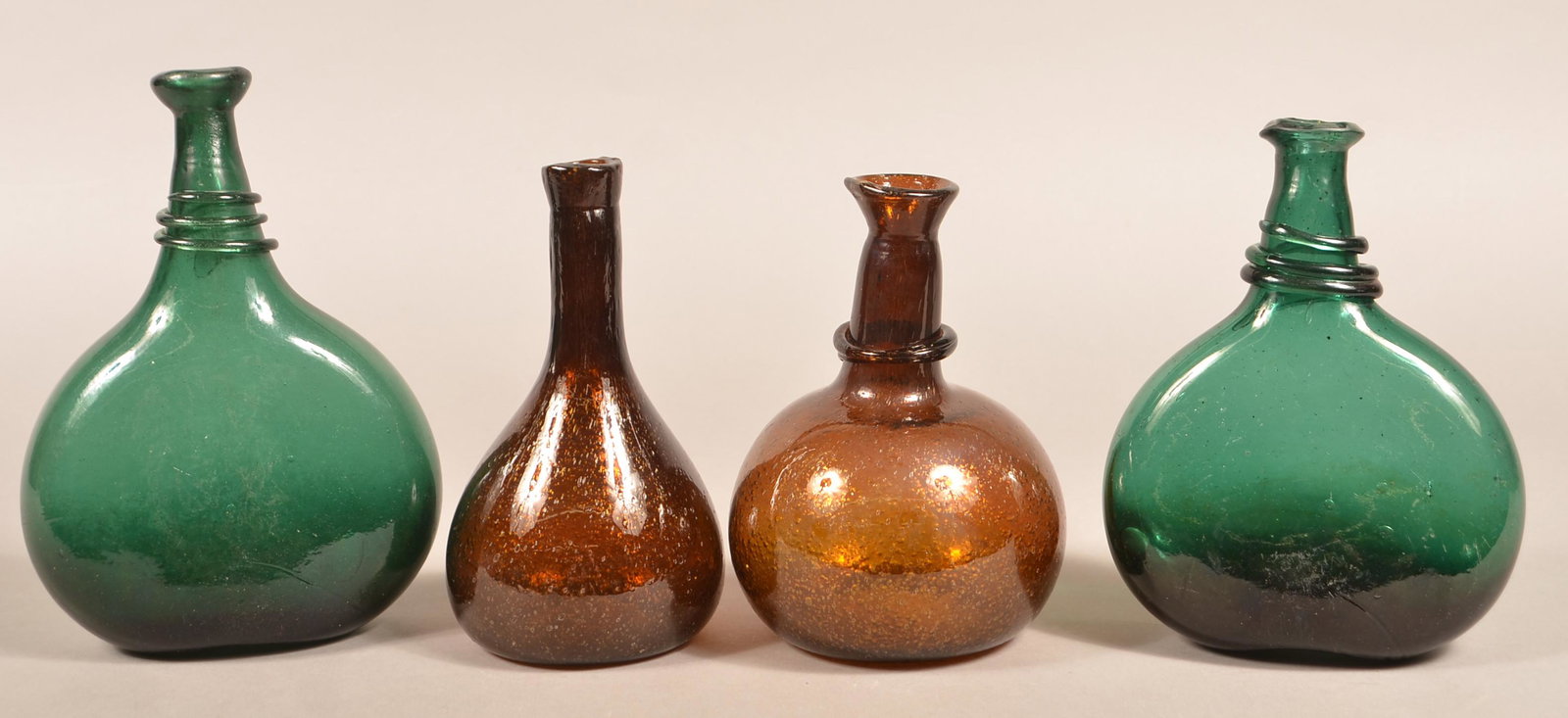 Four Antique Blown Glass Bottles.: Four Antique Blown Glass Bottles. Two green, two dark amber. Tallest 9"h. Condition: Good, no damage.