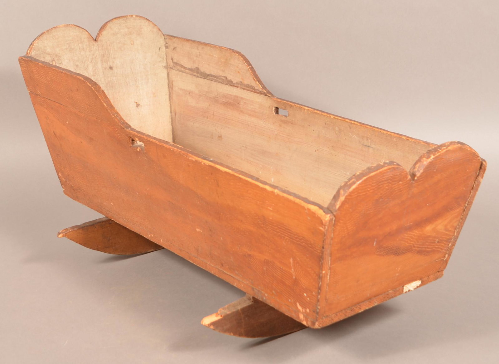 Antique PA Grain Painted Softwood Cradle.: Antique PA Grain Painted Softwood Cradle. Double arch cut-outs with cheese-cutter rockers. 32-1/2"l. Condition: Good with wear.