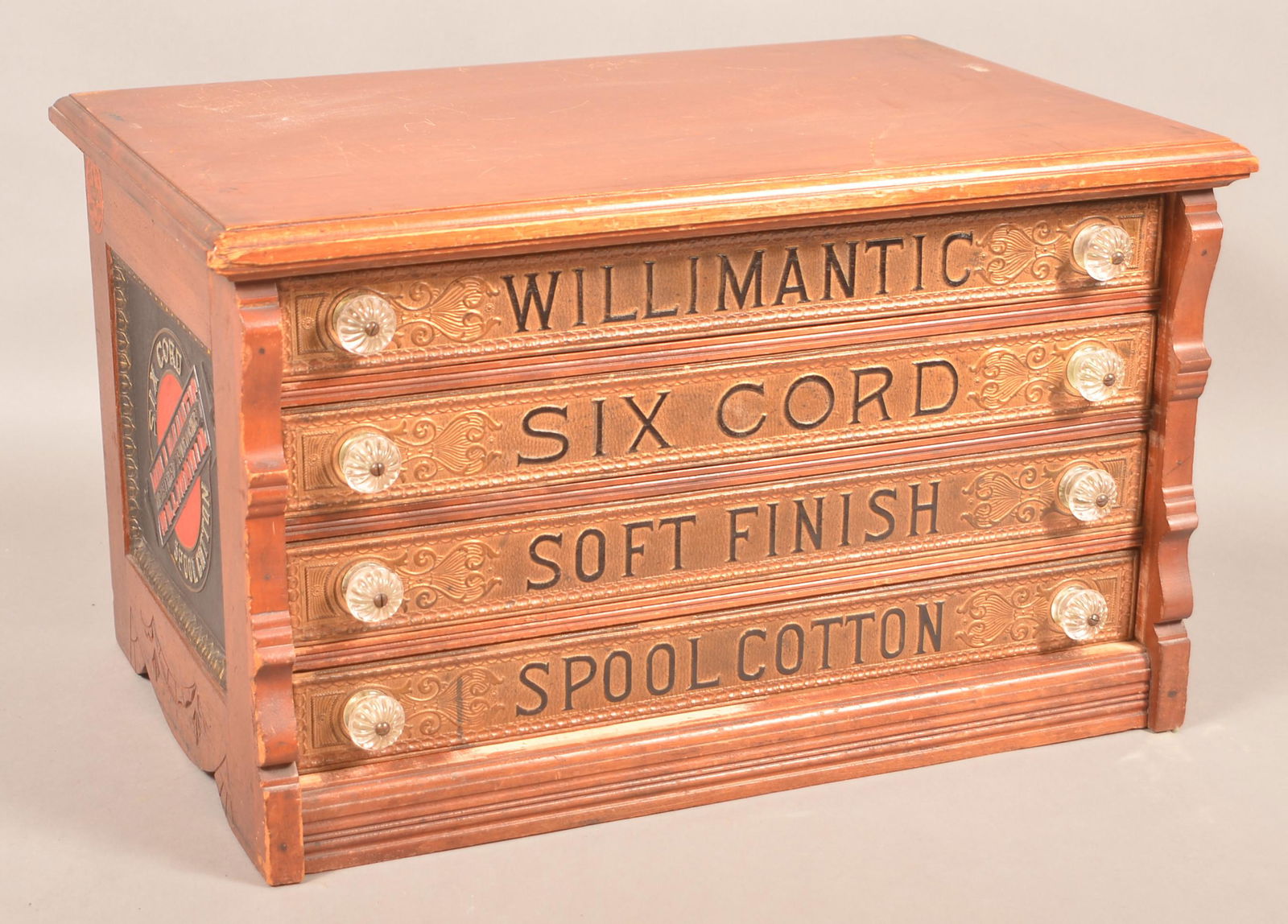 Victorian Willimantic Four Drawer Spool Cabinet.: Willimantic Four Drawer Spool Cabinet. Advertising on all four sides and a nicely detailed Victorian wooden case. 14-3/4"h. x 24-3/4'w. x 15-1/4"d. Condition: Very good with use wear.