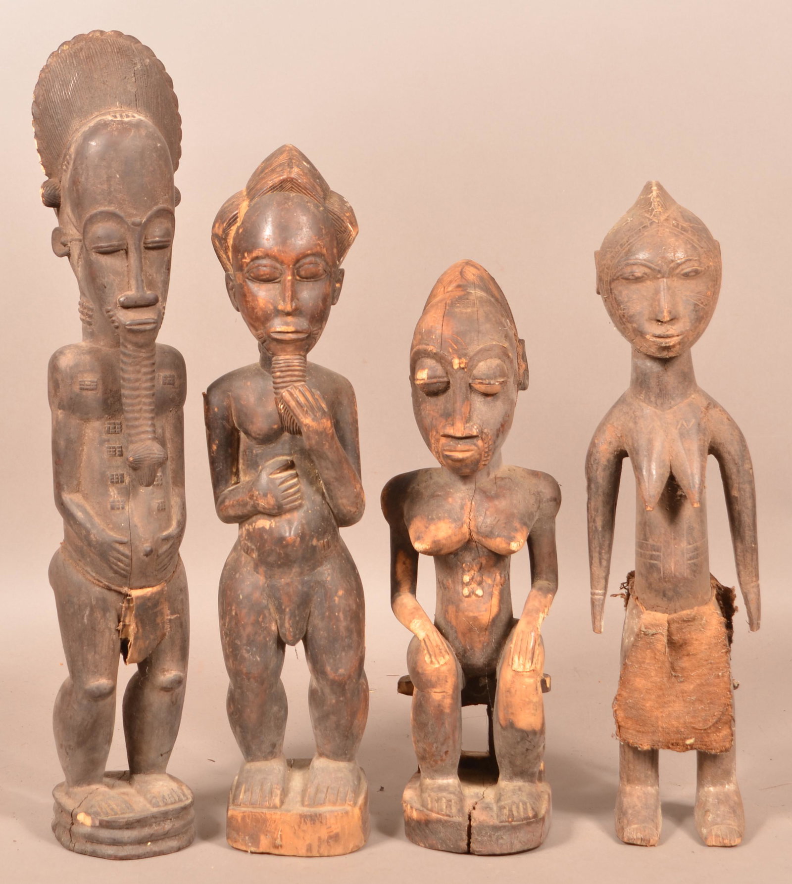 Four Antique/Vintage African Wood Tribal Figures.: Four Antique/Vintage African Carved Wood Tribal Figures. Tallest measures 28"h. Condition: Good with wear, cracks and losses.